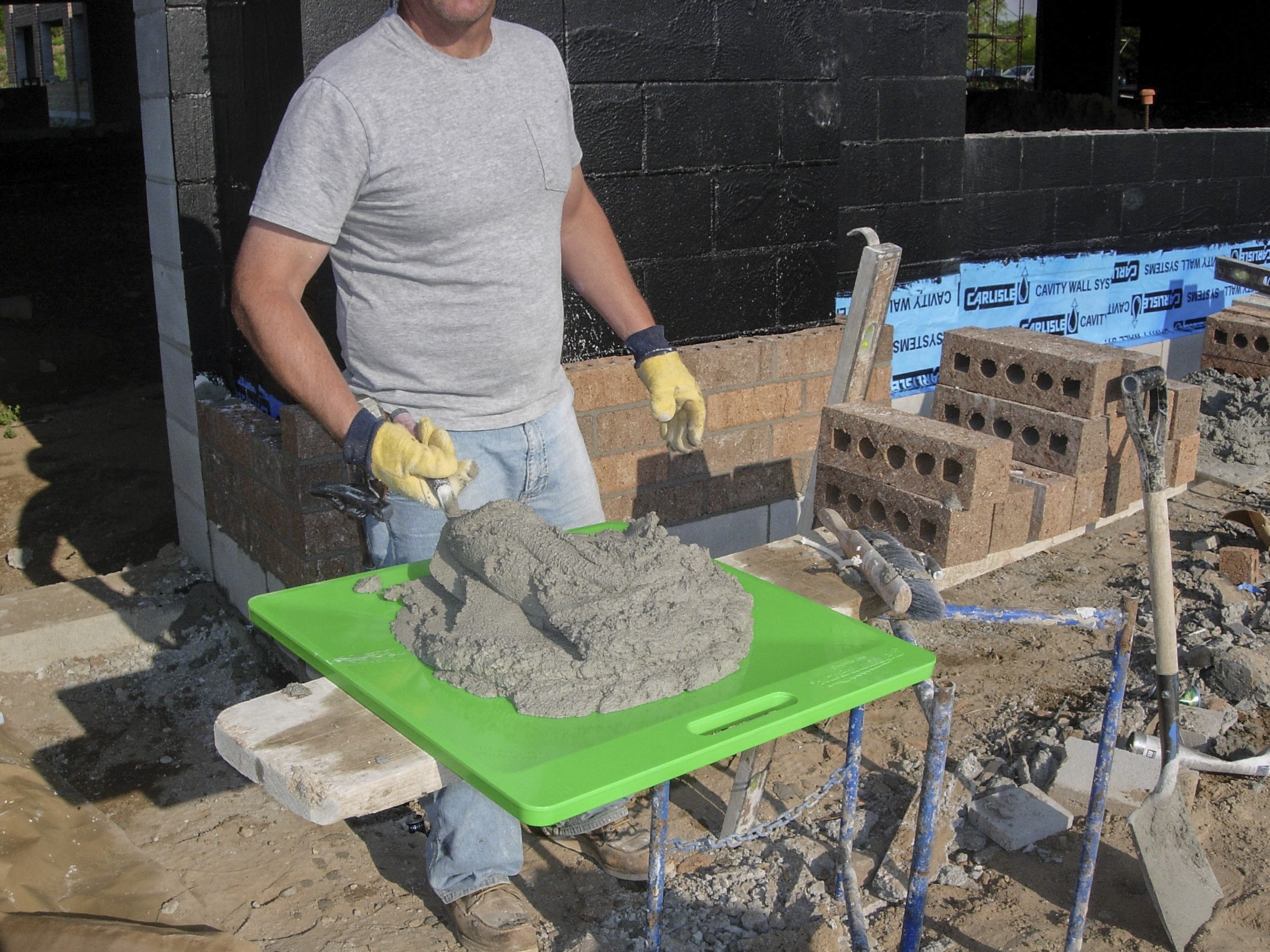 man laying brick and storing mortar on a Gatorback Mortar Board
